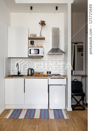 Trendy Modern Kitchen Design with Elegant White Cabinets and Charming Wooden Accents 125725689