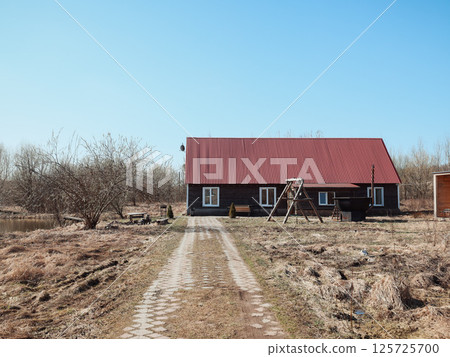 Charming Rustic House with a Distinctive Red Roof Surrounded by a Scenic and Picturesque Landscape Charming Rustic House with a Distinctive Red Roof Surrounded by a Scenic and Picturesque Landscape 125725700