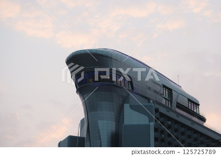 The Futuristic Architectural Design of a Skyscraper Represents Modern Ideas and Innovations 125725789