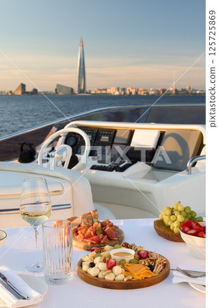 Experience Luxurious Yacht Dining Complete with Beautiful Scenic City Views and Ambiance Experience Luxurious Yacht Dining Complete with Beautiful Scenic City Views and Ambiance 125725869