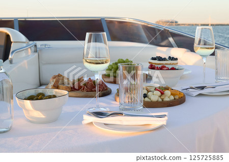 Experience a Gourmet Dining Adventure on a Luxurious Yacht While Enjoying the Sunset View Experience a Gourmet Dining Adventure on a Luxurious Yacht While Enjoying the Sunset View 125725885