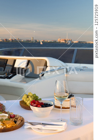Enjoy an Elegant Dining Experience on a Luxurious Yacht during a Stunning Sunset Enjoy an Elegant Dining Experience on a Luxurious Yacht during a Stunning Sunset 125725919