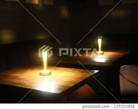 An Intimate Dining Setting Featuring Soft Ambient Lighting, Perfect for Memorable Evenings 125725958