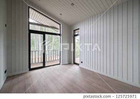 The Modern Interior of an Unfurnished Room featuring Large Windows for Ample Light The Modern Interior of an Unfurnished Room featuring Large Windows for Ample Light 125725971