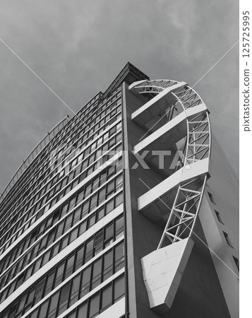 Modern Architectural Design featuring a Unique Curved Facade presented in Black and White 125725995