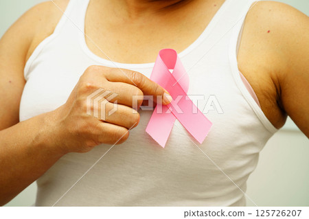 Asian woman with pink ribbon for October world breast cancer day. 125726207