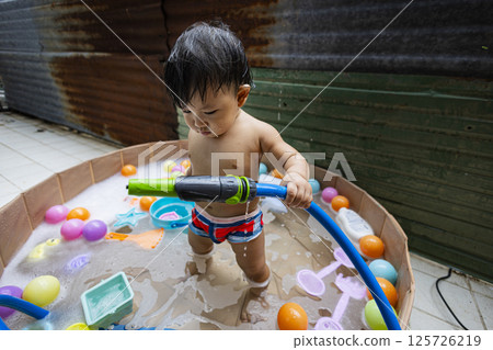 Children Playing In An Outdoor Bathtub, Background for advertising and wallpaper in relaxion and lifestyle scene. Children Playing In An Outdoor Bathtub, Background for advertising and wallpaper in relaxion and lifestyle scene. 125726219