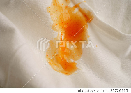Dirty tomato sauce stain removal or ketchup on cloth accident to wash with washing powder, cleaning housework. Dirty tomato sauce stain removal or ketchup on cloth accident to wash with washing powder, cleaning housework. 125726365
