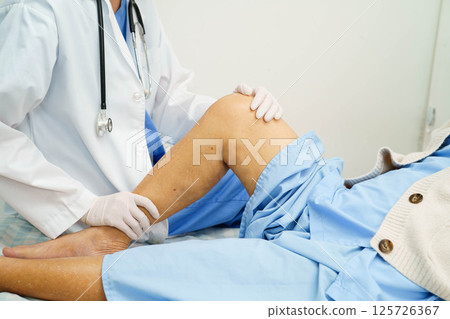 Doctor checking Asian elderly woman patient with scar knee replacement surgery in hospital. Doctor checking Asian elderly woman patient with scar knee replacement surgery in hospital. 125726367