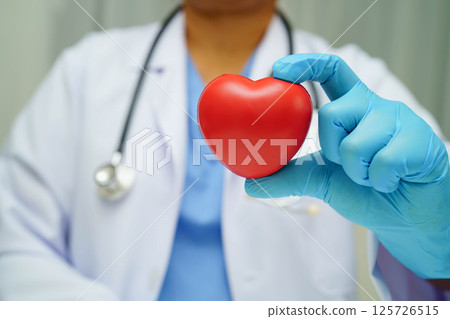 Asian woman doctor holding red heart for health in hospital. 125726515