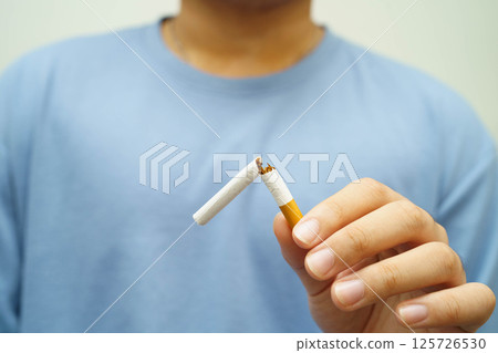 Quit smoking, Asian man breaking destroy cigarette in hand. Quit smoking, Asian man breaking destroy cigarette in hand. 125726530