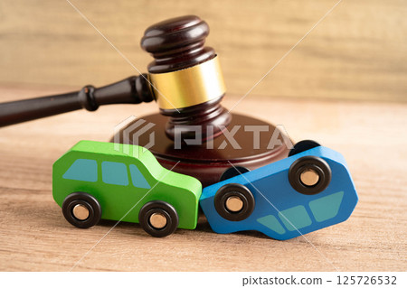 Car accident lawsuit and insurance, Judge hammer with car model. 125726532