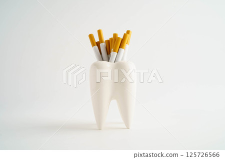 Cigarette with teeth isolated on white background, damage the health of your teeth, No smoking. 125726566