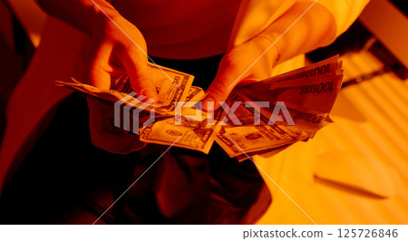 Businesswoman Counting Mixed US Dollars and Euros in Hands. 125726846