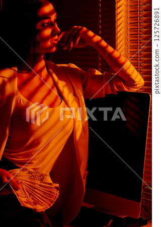 Elegant Businesswoman Holding Cash Near Window Blinds. Elegant Businesswoman Holding Cash Near Window Blinds. 125726891