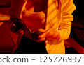 Businesswoman Counting Cash in Warm Office Lighting. 125726937