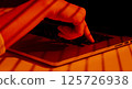 Finger Pressing Keyboard Button with Striped Light Shadows. 125726938