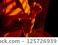 Closeup of Woman Stirring Mug in Cozy Office Lighting. 125726939
