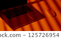 Modern Laptop and Mouse in Dramatic Orange Light. 125726954