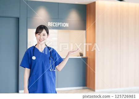 A female medical worker welcoming a patient A female medical worker welcoming a patient 125726981