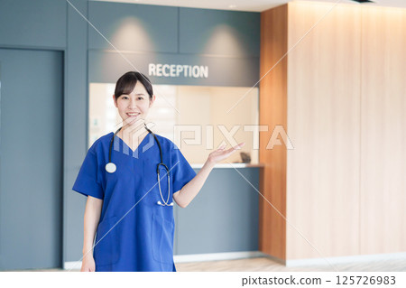 A female medical worker welcoming a patient A female medical worker welcoming a patient 125726983