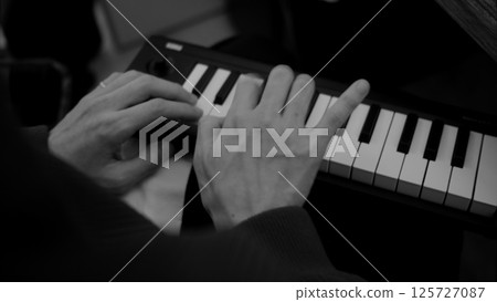 Hands playing a MIDI piano Hands playing a MIDI piano 125727087