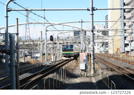 A Takasaki Line train leaving Saitama-Shintoshin Station A Takasaki Line train leaving Saitama-Shintoshin Station 125727226