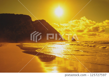 Rocky seascape in the evening. Golden sunset on the beach. Adraga beach, Portugal 125727597