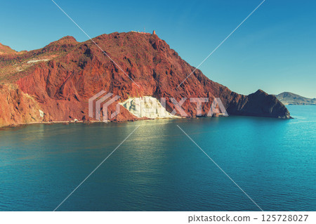 Rock in the sea. White rock in the mountain Cabo de Gata-Nijar reserve. Almeria, Andalusia, Spain 125728027