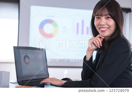 一位身穿西裝的女士正在製作演示文稿 125728079