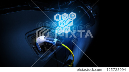 Power cable pump plug in charging power to electric vehicle EV car. Power cable pump plug in charging power to electric vehicle EV car. 125728994