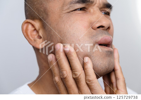 The man has facial swelling due to an allergic reaction to triggers such as insect bites stings The man has facial swelling due to an allergic reaction to triggers such as insect bites stings 125729738