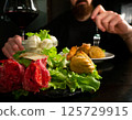 Man Dining with Red Wine and Appetizers 125729915