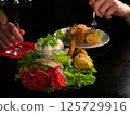 Culinary Encounter: Savoring Red Wine with a Diverse Selection of Appetizers 125729916