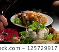 Elegant Dining: Red Wine and Gourmet Appetizers 125729917