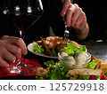 A Culinary Moment: Red Wine Accompanies a Delectable Plate of Mixed Appetizers 125729918