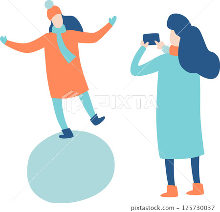 Woman with smartphone taking picture of her female friend balancing on a snowball, both wearing winter clothes, simple flat vector illustration Woman with smartphone taking picture of her female friend balancing on a snowball, both wearing winter clothes, simple flat vector illustration 125730037