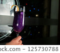 Sparkling Purple Cocktail with Lemon Twist 125730788