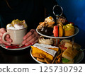 Enjoying Afternoon Tea with Coffee and Pastries 125730792