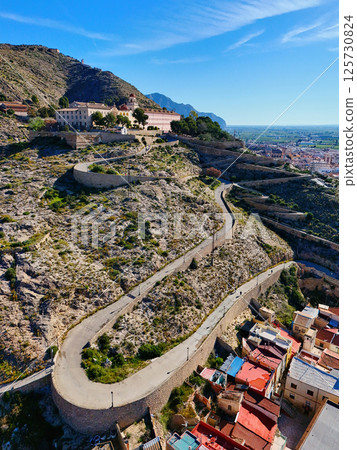 Curvy road goes up hill of San Miguel Diocesan Seminary. Orihuela 125730824