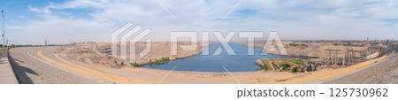 Wide panoramic view of Aswan High Dam and Lake Nasser on a clear spring morning. Wide panoramic view of Aswan High Dam and Lake Nasser on a clear spring morning. 125730962