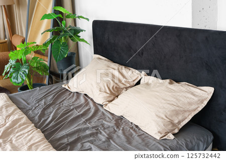 Cozy bedroom setting with pillows and cotton soft on black headboard background 125732442
