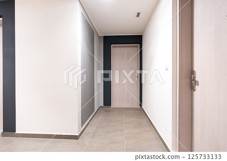 Modern apartment entrance door with peephole and security lock. 125733133