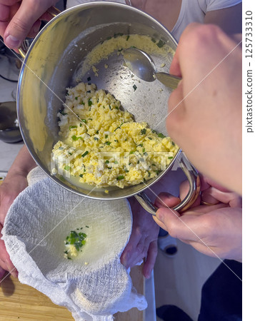 Process of making homemade cheese with green onion feathers. Process of making homemade cheese with green onion feathers. 125733310