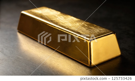 Close-up of a shiny gold bar with smooth surface and rectangular shape, resting on a reflective dark surface with soft lighting highlighting its metallic texture Close-up of a shiny gold bar with smooth surface and rectangular shape, resting on a reflective dark surface with soft lighting highlighting its metallic texture 125733426