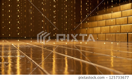 Shiny wet wooden floor with reflections and golden brick wall background illuminated by warm ambient lighting, creating a cozy indoor atmosphere 125733677