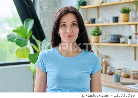 Headshot portrait young smiling woman at home in kitchen Headshot portrait young smiling woman at home in kitchen 125733789