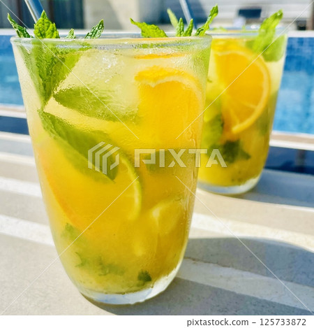 Refreshing Orange Mojito by the Pool 125733872