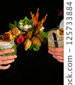 Sharing Cocktails and Appetizers black background 125733884
