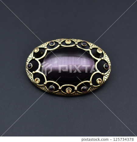 Vintage brooch floral detail closeup on soft background Vintage brooch floral detail closeup on soft background 125734378